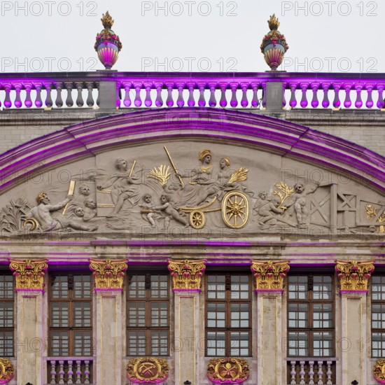 The illuminated gable of the guildhall Le Moulin à Vent and Pot d'Étain in the evening,