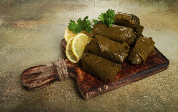 Dolma, minced meat with rice, in grape leaves, minced meat rolls, on a chopping board, top view, no