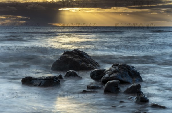 Rocks on the beach of Playa del Inglés. Sunset. Sea and waves. Long exposure. Valle Gran Rey, La