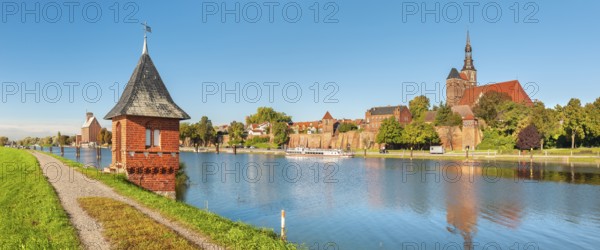 View over the Elbe harbour with water gauge tower to the old town with St. Stephen's Church, brick