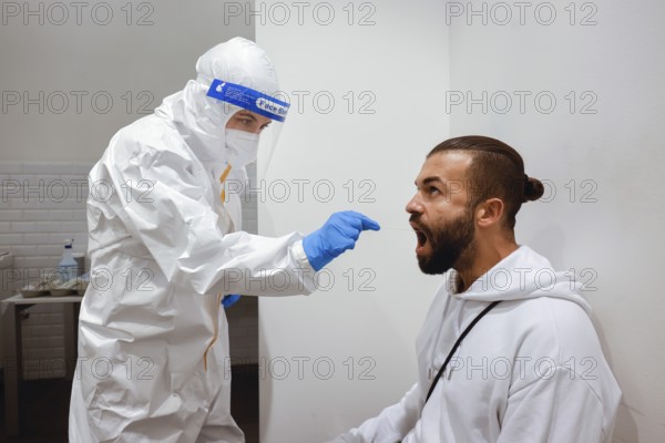 Cologne, North Rhine-Westphalia, Germany - Covid rapid test at the Medicare test centre, throat