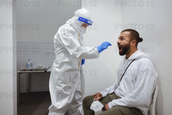 Cologne, North Rhine-Westphalia, Germany - Covid rapid test at the Medicare test centre, throat