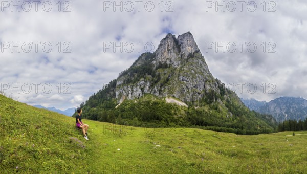 Hiker on the Schartenalm with a view of the Sparber, Osterhorn group, Salzkammergut, Salzburg