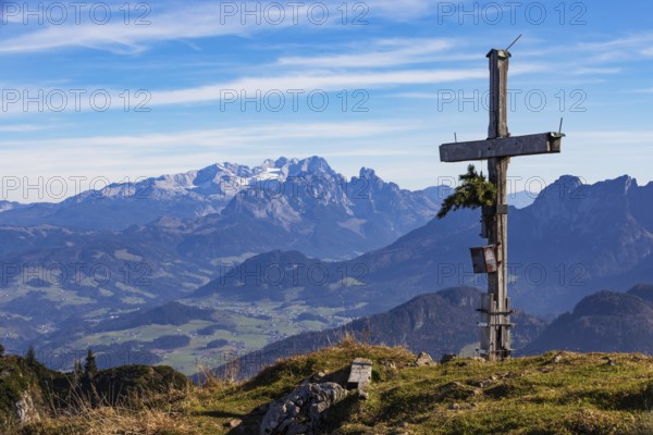 Old summit cross on the Schwarzer Berg with a view of the Lammertal valley and Dachstein massif,