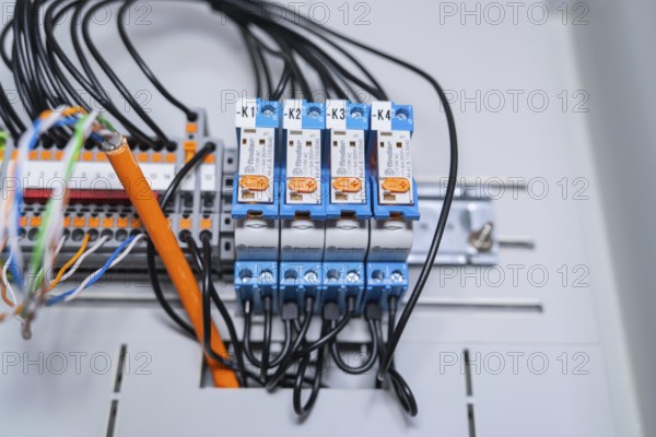 Functional arrangement of blue relays, wired in an electrical system, precise technology visible,