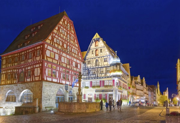 Half-timbered houses in the Herrngasse in the old town of Rothenburg ob der Tauber, illuminated at