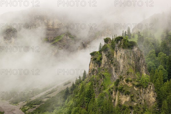 Wisps of mist cover the Karwendel mountains in the Großer Ahornboden nature reserve, Eng Valley,