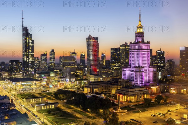 Warsaw skyline skyscrapers with Palace of Culture in the city centre at night in Warsaw, Poland,