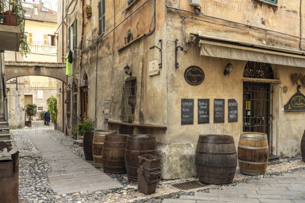 Old wooden barrels from a restaurant in the historic centre of Finalborgo, Finale Ligure, Riviera