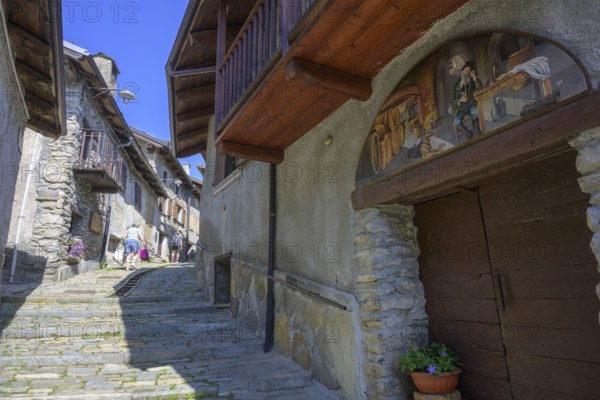 Pictures on the house walls characterise the narrow streets with old houses in the village,