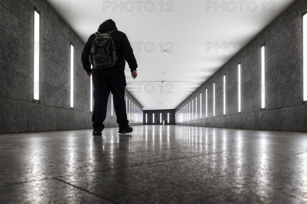 A man walks through the tunnel subway illuminated with LED light to the underground station Museum