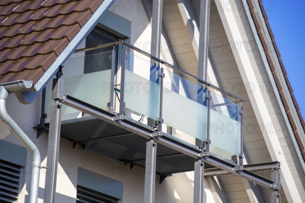 Balcony railing made of glass and stainless steel on a residential building