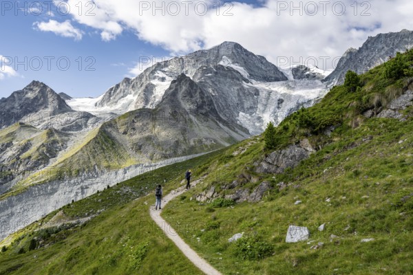Mountaineer on a hiking trail, mountain landscape near Arolla, behind mountain peak Mont Collon and