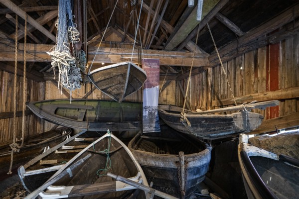 Old fishing boats in a shed, fishing village Nusfjord, Lofoten, Norway, Europe