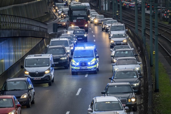 Traffic jam on the A40 motorway, emergency lane, vehicles on the left and right, police patrol car