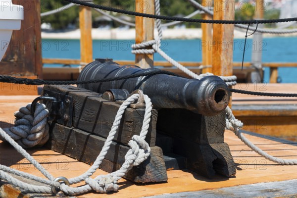 Detailed view of an old cannon on board a wooden ship with maritime elements, Ship Galija, Amadria