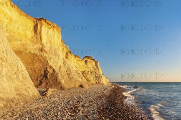 The high shore in the evening light, beach with pebbles, steep coast near Ahrenshoop,