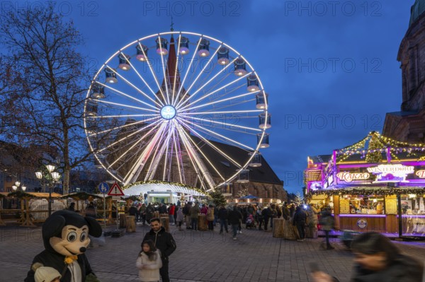 Ferris wheel at the winter village, Christmas market at dusk, St Elisabeth's Church on the right,