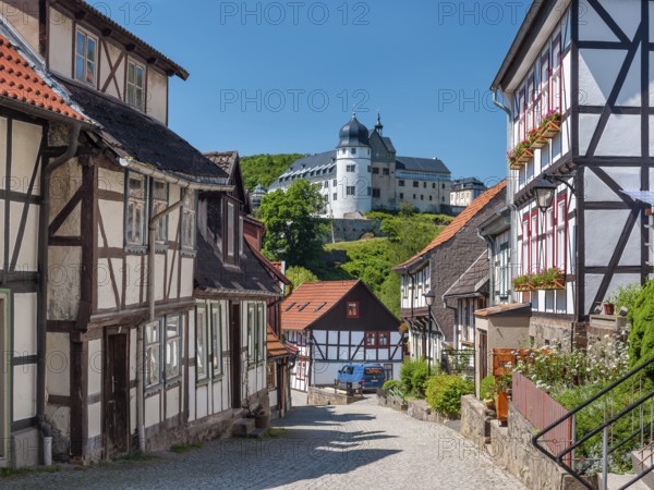 Street with half-timbered houses and cobblestones in the historic old town, behind the castle,