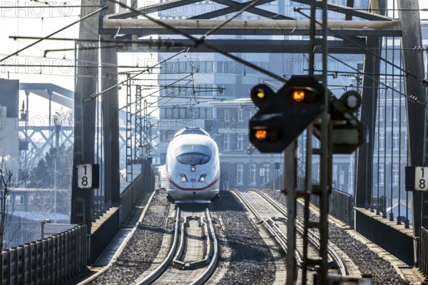 ICE en route on a railway bridge with tracks and signalling system. Mannheim, Baden-Württemberg,