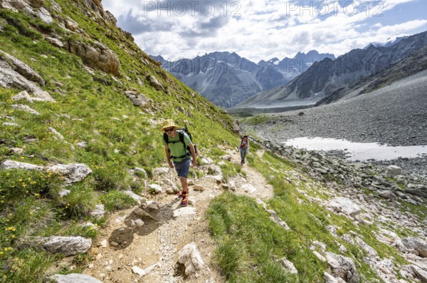 Mountaineer on a hiking trail, mountain landscape near Arolla, ascent to Col de Riedmatten, Valais,