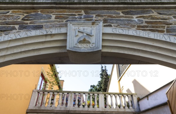 Architectural combination of old and new, keystone with initials and sandstone railing of a terrace