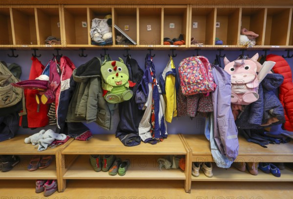 Germany - Symbolic image KITA. Children's coats, jackets and unicorn rucksacks hang on a coat rack
