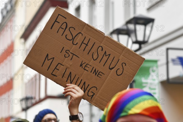 Heidelberg, Germany - February 12th 2025: Person holding up sign with text 'Fascism is not an