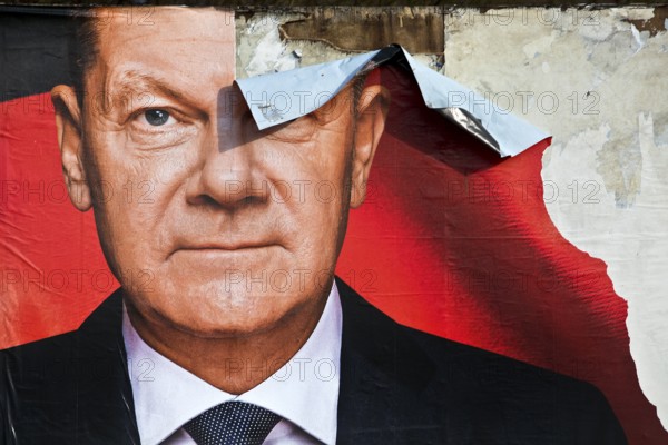 Partially destroyed large poster for the 2025 federal election by the SPD with Olaf Scholz, Witten,