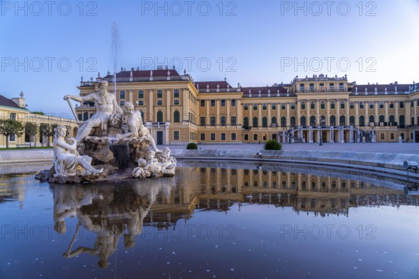 Fountain in the courtyard of honour at Schönbrunn Palace at dusk, UNESCO World Heritage Site in