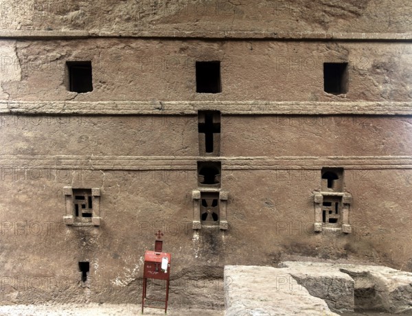 Underground monolithic rock church Biete Maryam, east side with cross windows carved in stone,