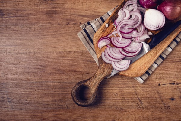 Sliced red onion, on a chopping board, with a knife, Spanish onion, raw onion, close-up, top view
