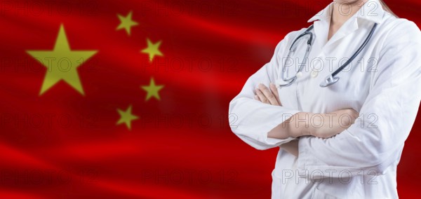 Doctor with crossed arms on China flag. China Health and Care concept. Female doctor on China flag