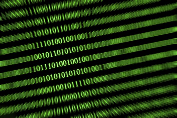 Slanted green binary code on a black background, conveys speed