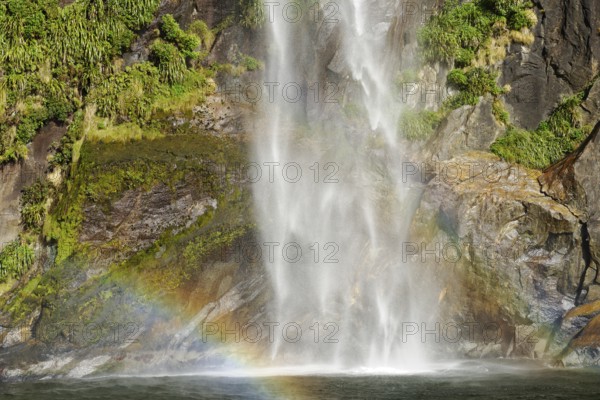 Rainbow over waterfall, Milford Sound, Fiordland National Park, South Island, Southland, New