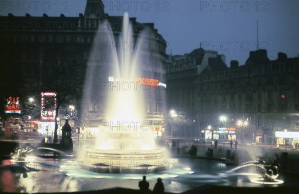 Illuminated fountain and neon lights in Trafalgar Square in the centre of London, England, United