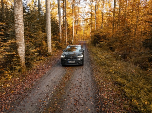 A car on a wooded path, surrounded by dense autumn landscape, electric car, VW ID5, Gechingen,