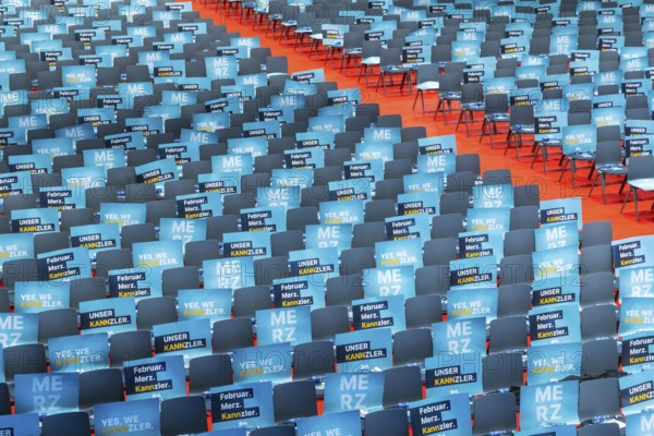 Assembly hall, deserted with many empty chairs and posters with the inscription UNSER KANNZLER.