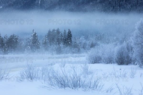Isar valley in winter at temperatures of minus 18 degrees Celsius. Snow covered landscape with the