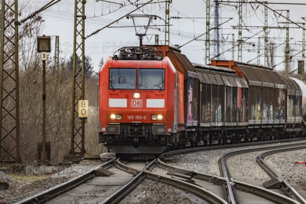Goods train travelling on the winding Schuster Railway, overhead lines and infrastructure.