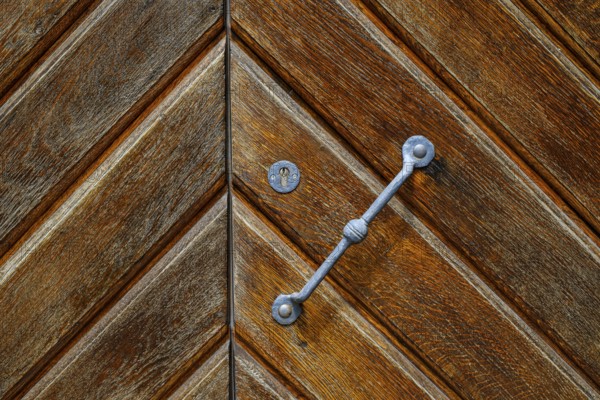 Detail of a historic iron-framed wooden door in the outer wall of the Old Palace in Stuttgart,