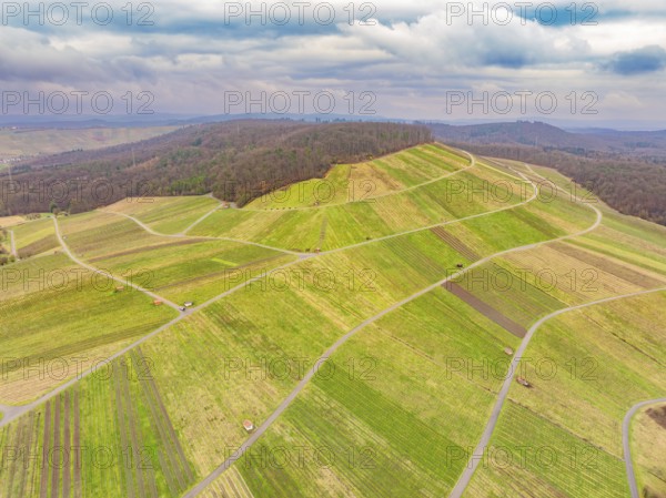 Wide, patterned fields on rolling hills under a cloudy sky, Großbottwar, Ludwigsburg district,