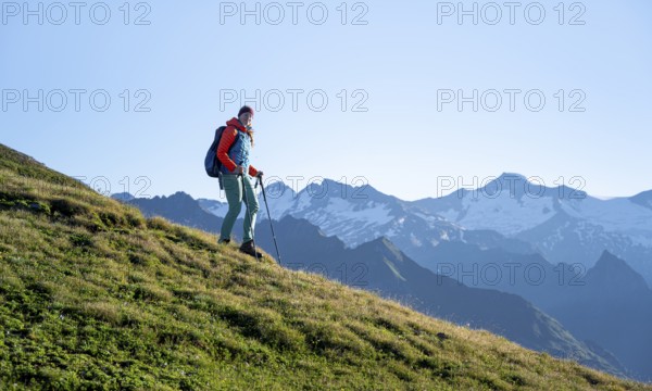 Hiker enjoying the mountain panorama in the morning, Venediger group, behind Dreiherrenkopf,
