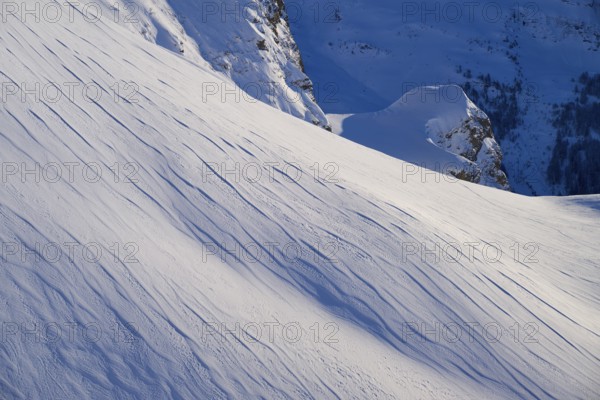 Snow-covered slopes with fine lines under a blue sky, quiet winter atmosphere, Gemmi Pass,