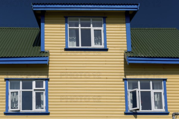 Blue-yellow-green painted wooden house, blue sky, Mykines, Útoyggjar, Faroe Islands, Denmark,