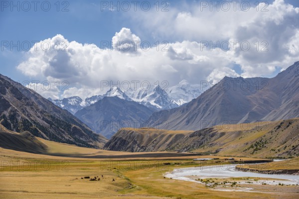 Mountain river in a valley, picturesque mountain landscape with white mountain peaks, Tian Shan