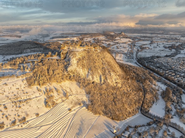 Aerial view of the snow-covered Hegau volcano Hohentwiel with Germany's largest castle ruins on a