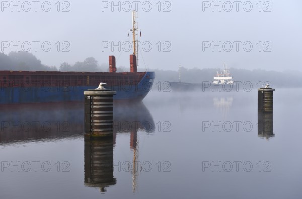 Cargo ship sailing in fog in the Kiel Canal, Kiel Canal, Schleswig-Holstein, Germany, Europe