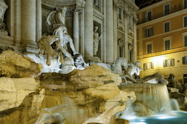 Night shot with long exposure photo side view of sculptures in Trevi Fountain Fontana di Trevi with