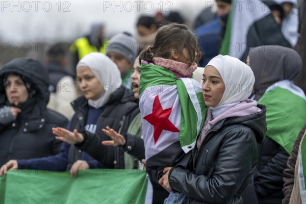 Syrian woman celebrate the end of the Assad regime after the change of power in Syria at a rally on